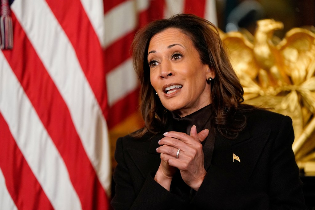 US Vice President Kamala Harris speaking to her staff before signing the inside of her White House desk as part of a long tradition