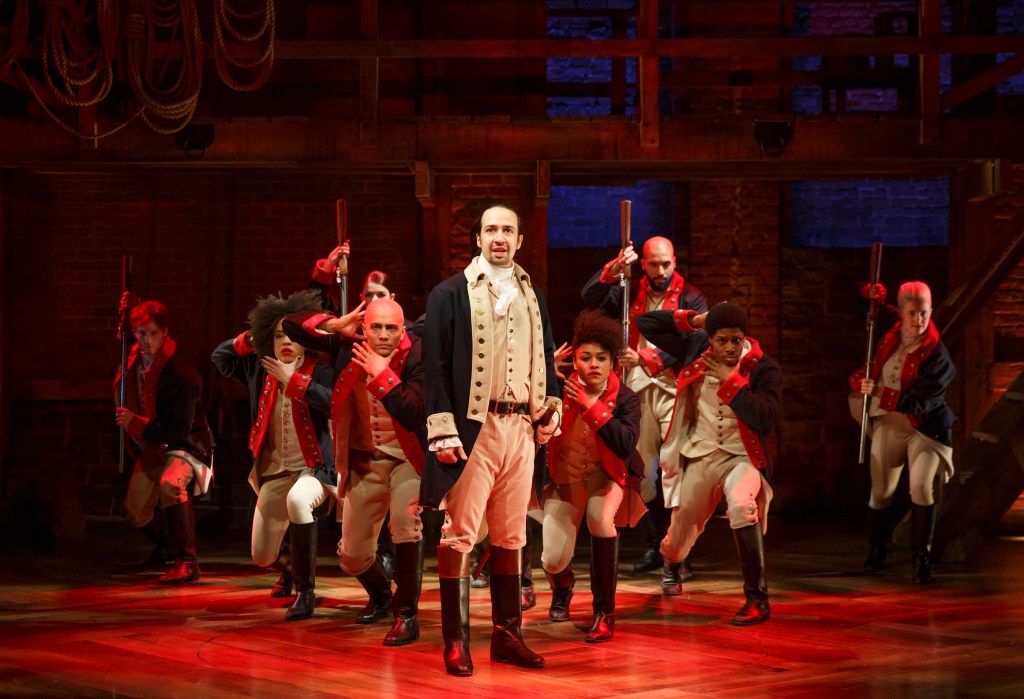 In this image released by the Public Theater, Lin-Manuel Miranda, in the center, performs in musical "Hamilton" at the Public Theater in New York.